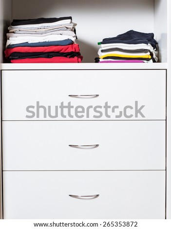 Casual clothes in a wardrobe - color image