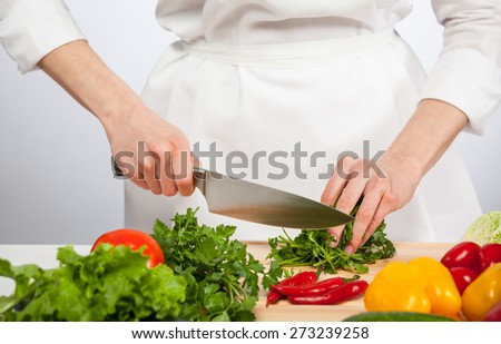 Cook\'s hands preparing vegetable salad - closeup shot