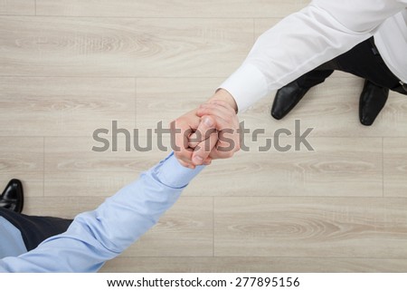 Businessmen\'s hands demonstrating a gesture of a strife or solidarity, view from above