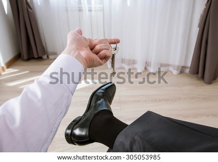 Unrecognizable businessman holding a bunch of keys in informal atmosphere