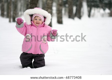 Cheerful baby glad to first snow