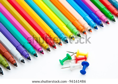 Diagonal fragment of opened colorful markers; white background