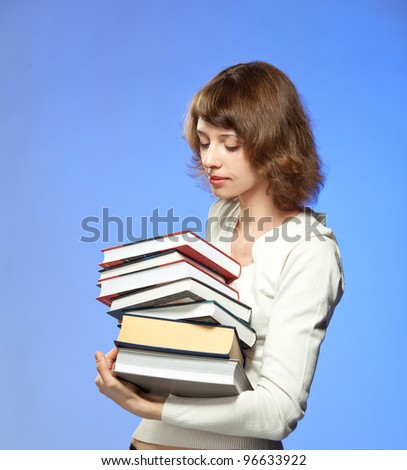 A portrait of a young woman holding a stack of books; colored background
