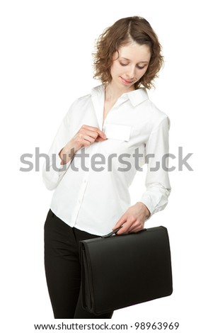 Beautiful young woman with briefcase showing blank name badge, you can write your text on it; studio shot isolated on white