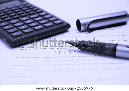Still life of a calculator and an open pen on scientific paper, shallow dof with focus on the tip of the pen, tinted blue