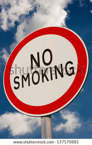 No smoking sign against a blue sky.