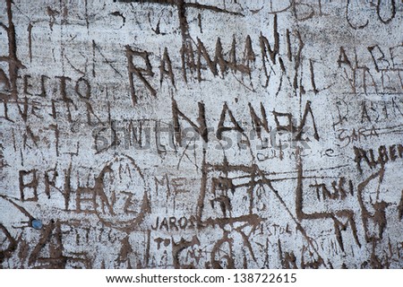 A wall with etched on graffiti. Good background image.