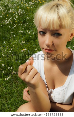 Portrait of young blond girl in a natural background