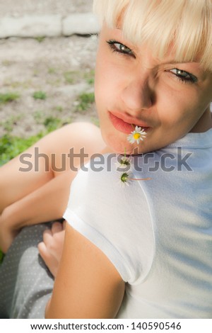 Portrait of young blond girl in a natural background