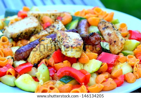 Pasta dish with vegetables and grilled turkey and merguez