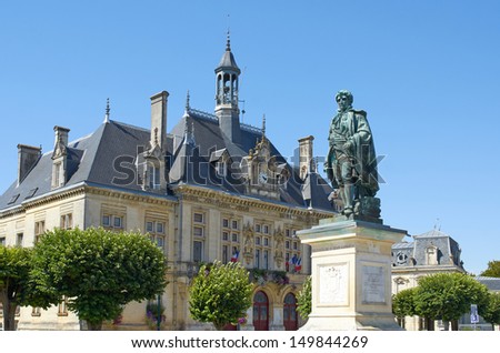 City Hall of St Jean d\'Angely with bronze statue of Regnaud de St Jean d\'Angely, Charente Maritime, France