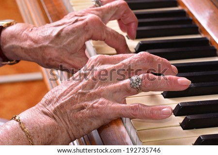Old woman close up of hands  playing the piano