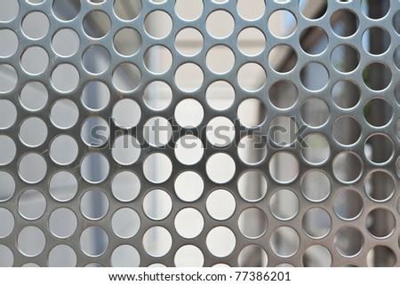 Full frame silver metal mesh screen with holes.