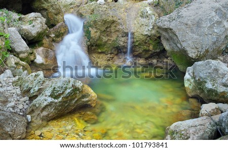 Waterfall and greater stones. Natural composition