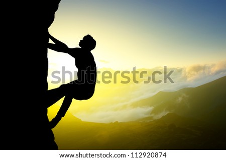 Rock climber on background of sundown. Sport and active life