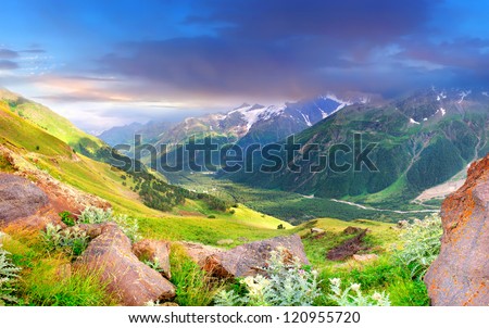 Mountain valley and dark sky before storm. Natural summer landscape