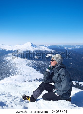 Tourist on the snow mountain top. Sport and active lifestyle