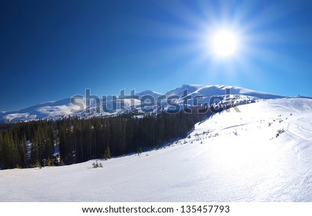 Mountains and sun glow at the winter time. Beautiful landscape