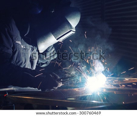 Welding and bright sparks. Concept and idea of hard job