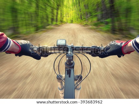 Ride on bicycle on road in summer forest. Sport and active life concept