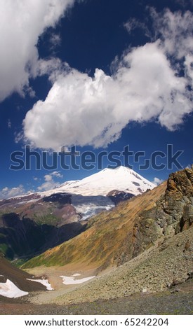Vertical panorama with snow mountain and white cloud