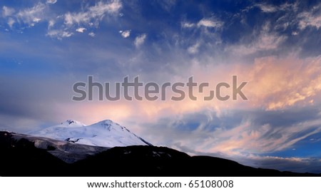 Dawning in blue and rose tone on snow mountain. Natural composition