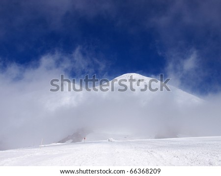 Big white cloud closes the mountain. Natural composition