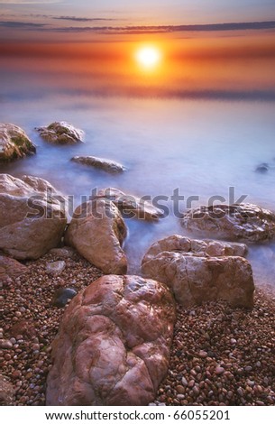 Stone and sea during sundown. Natural composition