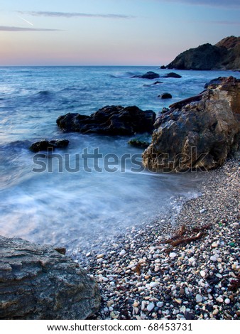 Sea stone and waves during sundown. Natural composition