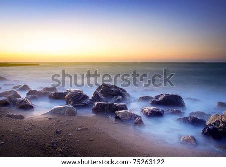 Mist amongst stone on seashores. Composition of the nature