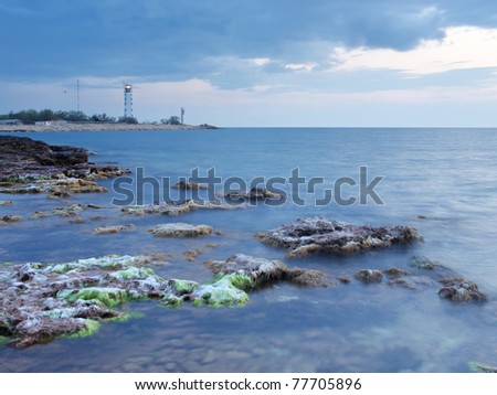 Seascape and a small lighthouse. Composition of nature
