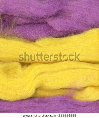 Felt wool. Abstract textured background. Dark pink, purple, violet and yellow colors.  Woolen
