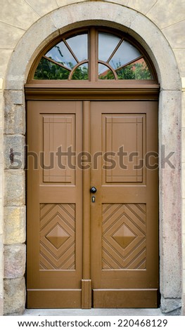 Historical Ornate Wooden Door in a Stone Entry with Arc and Glass Panes, Prague, The Czech Republic