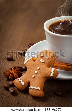 Coffee with gingerbread man  on a wooden background