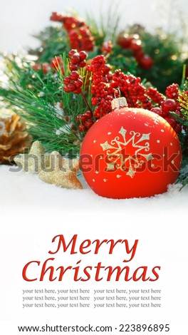 Christmas background with red ornaments, gold star, berries and spruce in the snow