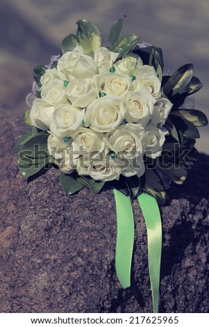 Brides bouquet of  white roses before wedding, vintage toning