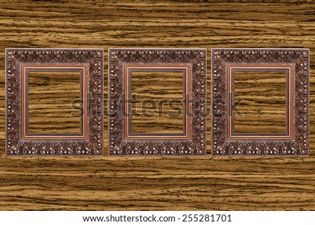 three Vintage wooden frame on wood textured background