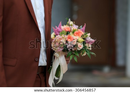 wedding bouquet in hands of the groom. Wedding vows
