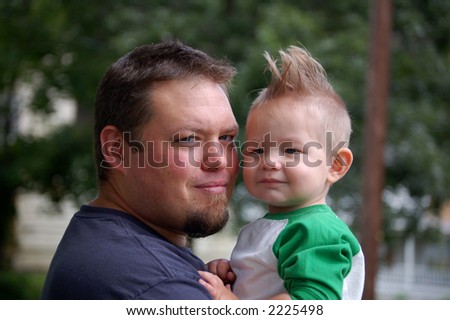 young father holding his one year old son
