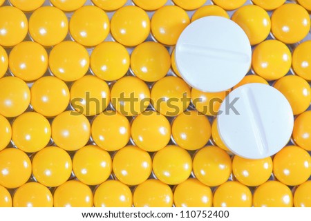 medical pills on yellow pills background