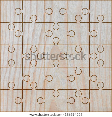 jigsaw puzzle frame on light brown wood background.