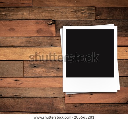 blank photo frames and free space on left side on brown wood texture background
