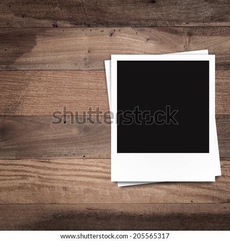 blank photo frames and free space on left side on brown wood texture background