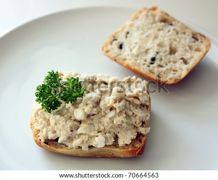Slice of bread with fish paste and parsley