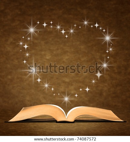open old book. a star, heart graphic at the top of the book.
