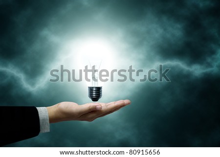 Light bulb hanging on business men. The background is a green lightning bolt