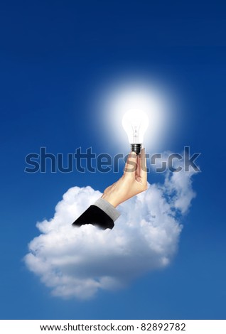 Bulb light in business woman hand on the sky the clouds
