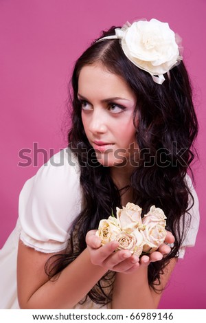 Portrait of young beautiful woman with long glossy hair and flowers