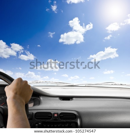 Steering wheel of a car and sky background