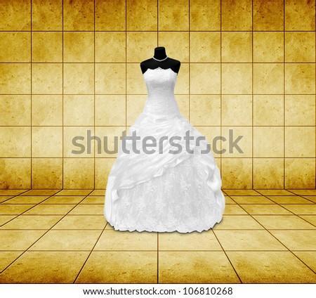 wedding dress on a mannequin in golden room